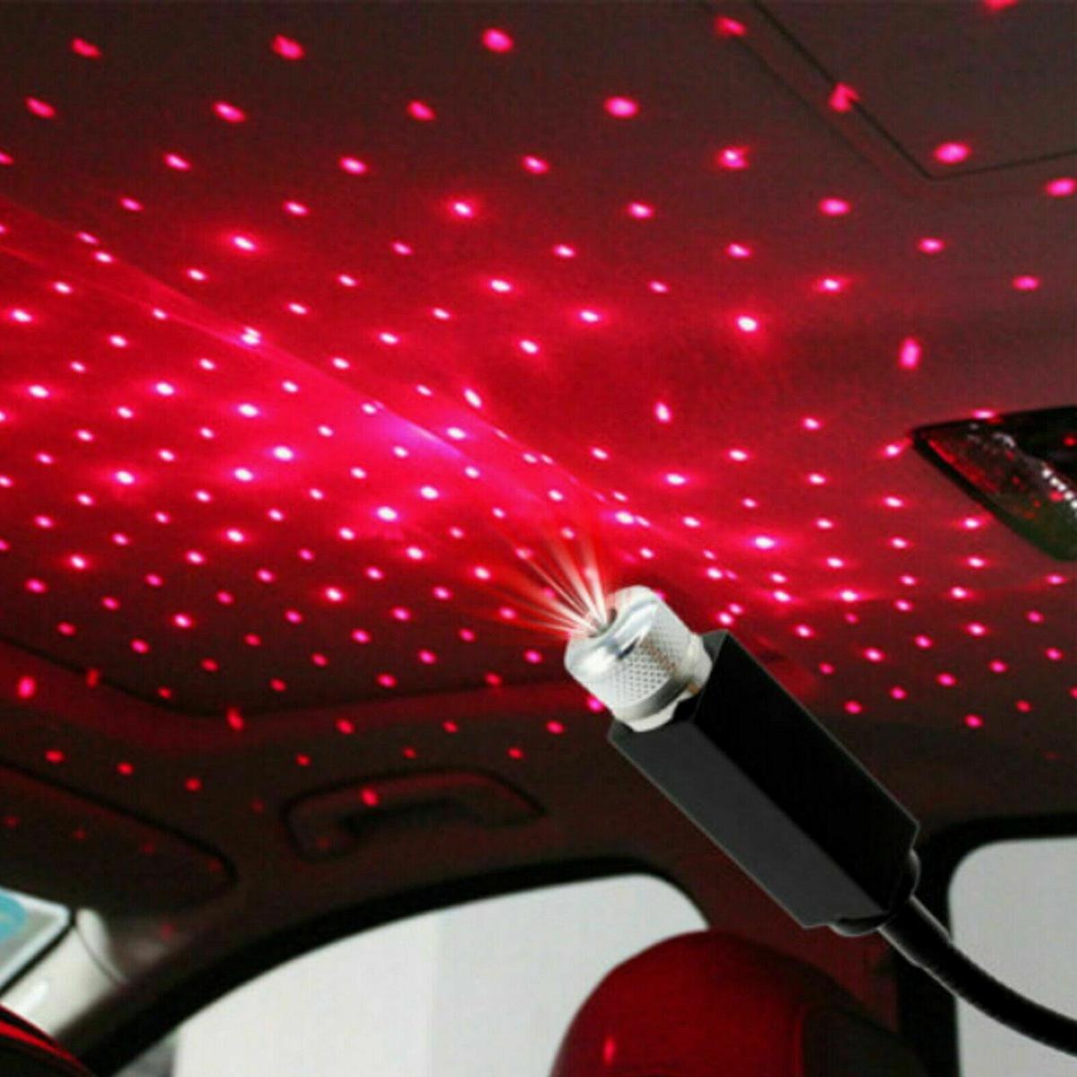 Car interior with starlight effect projected onto the ceiling using a red LED light projector.