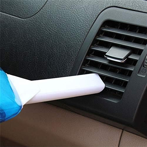 Car vacuum cleaning nozzle attachment being used on a car air vent