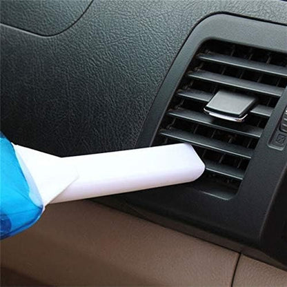 Car vacuum cleaning nozzle attachment being used on a car air vent